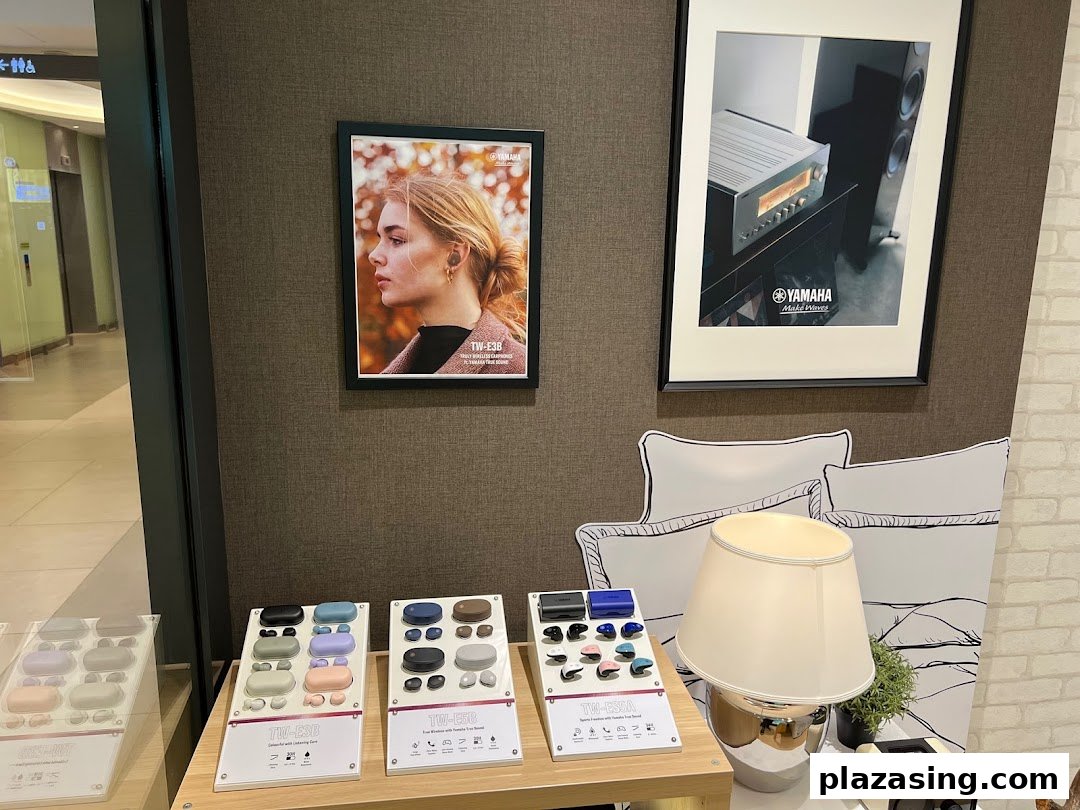 An interior shot of Yamaha AV Experience Studio showcasing wireless earbuds and audio equipment displays.