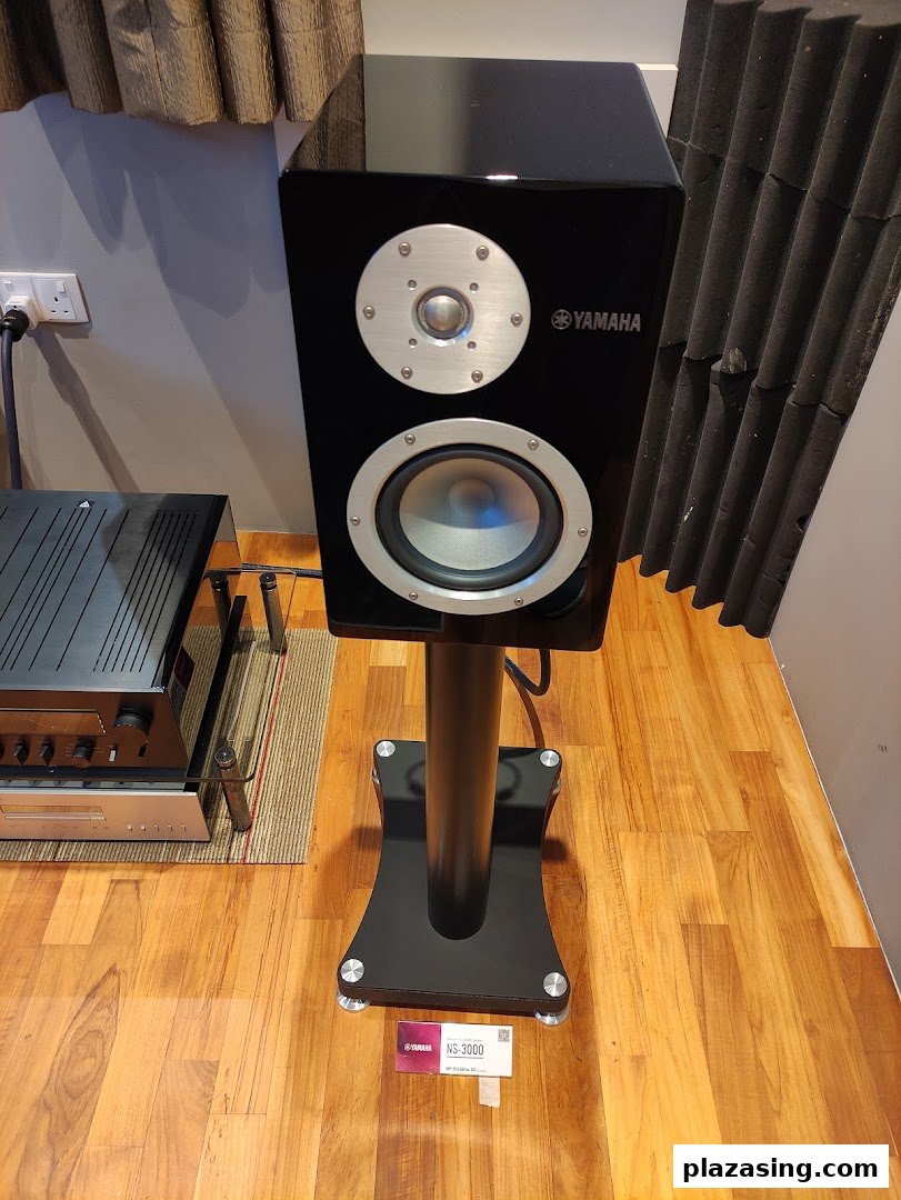 A sleek black Yamaha NS-3000 speaker on a stand, showcasing premium audio equipment.