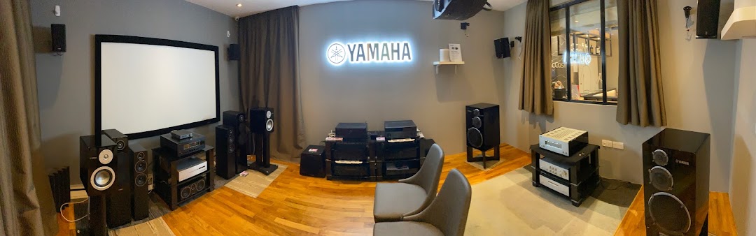 An immersive home theater setup featuring Yamaha audio-visual equipment and a large projection screen.