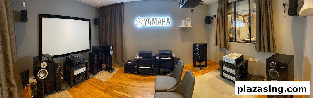 An immersive home theater setup featuring Yamaha audio-visual equipment and a large projection screen.