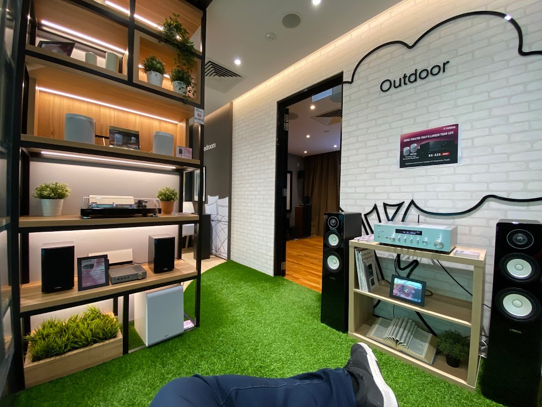 An immersive display of Yamaha audio-visual equipment in simulated home and outdoor settings.