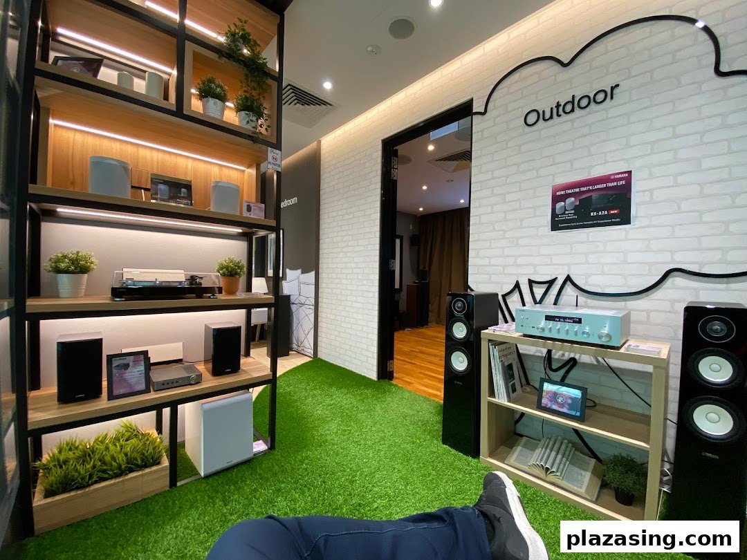 An immersive display of Yamaha audio-visual equipment in simulated home and outdoor settings.