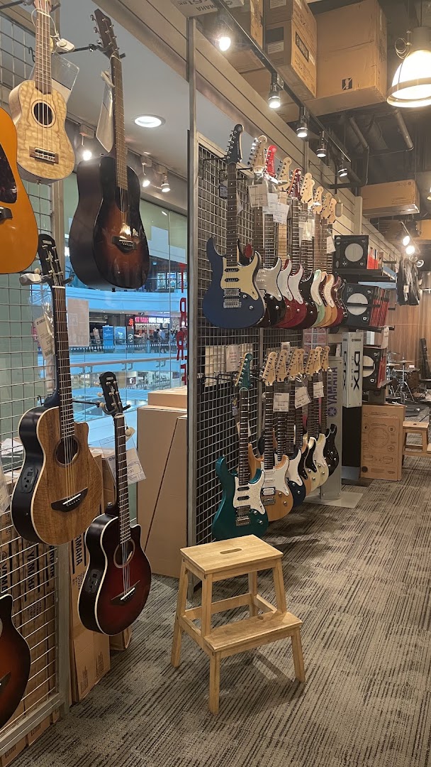 Interior view of a Yamaha Music Store showcasing a wide array of acoustic and electric guitars.