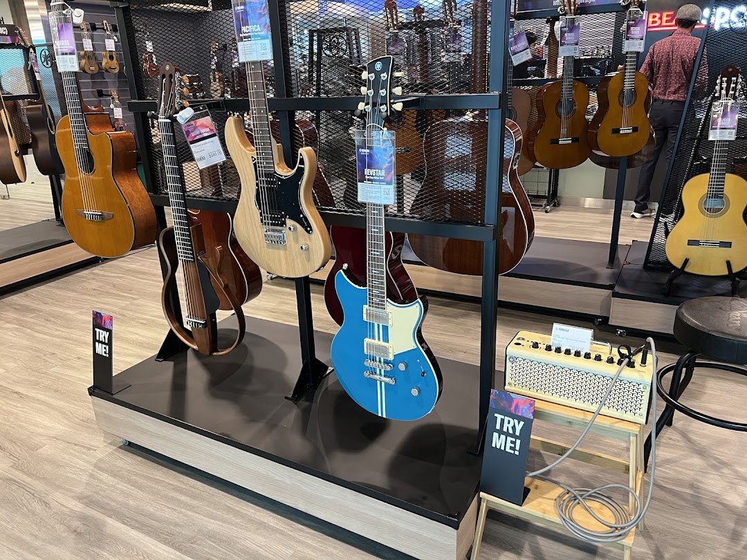 A vibrant display of acoustic and electric guitars, showcasing Yamaha's musical instrument collection in-store.