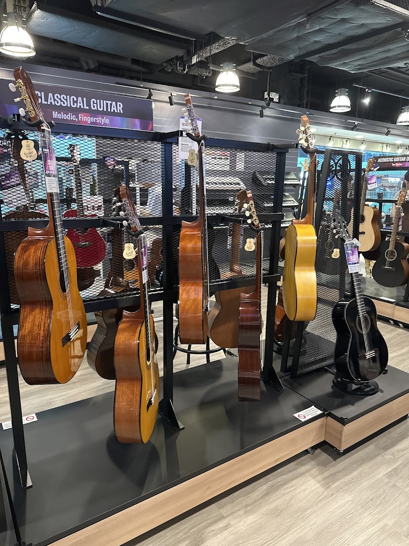 An interior shot of Yamaha Music Store showcasing a wide selection of classical and acoustic guitars on display.