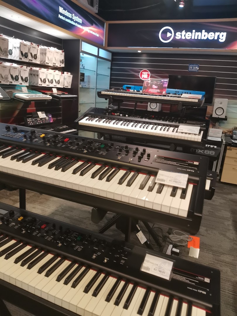 A vibrant display of Yamaha digital pianos and keyboards, alongside headphones, in a music store.