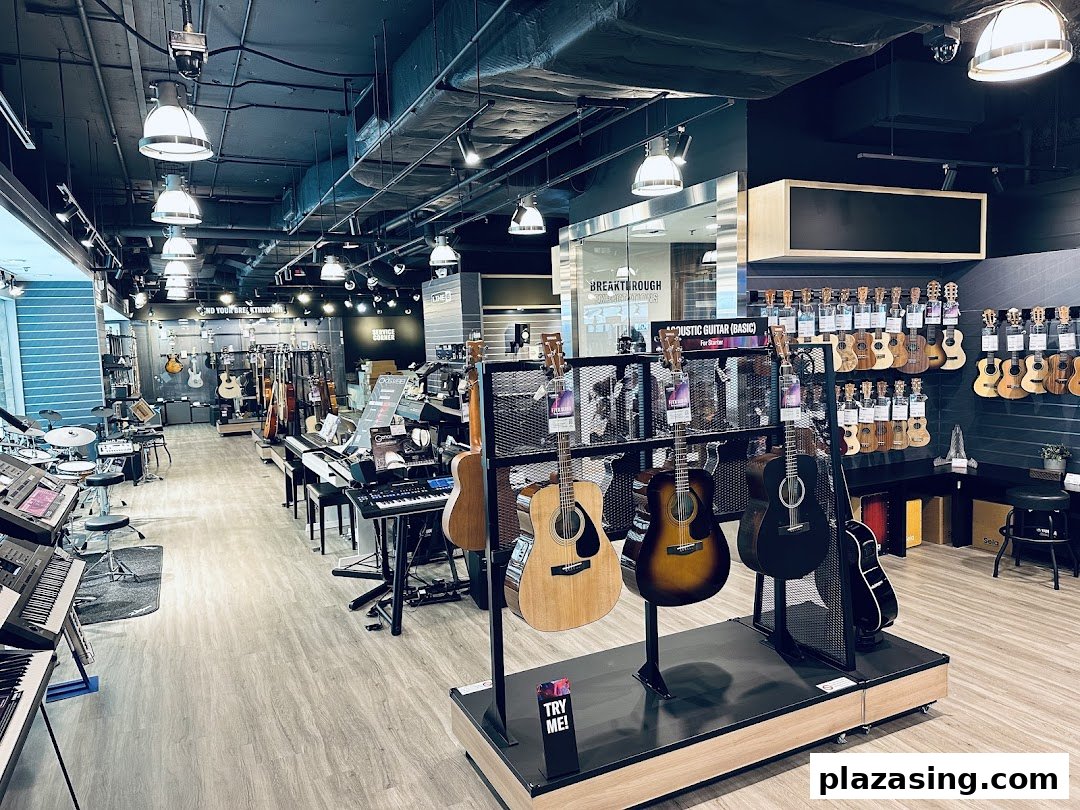 An interior view of Yamaha Music Store, showcasing a wide selection of guitars, ukuleles, keyboards, and drums.