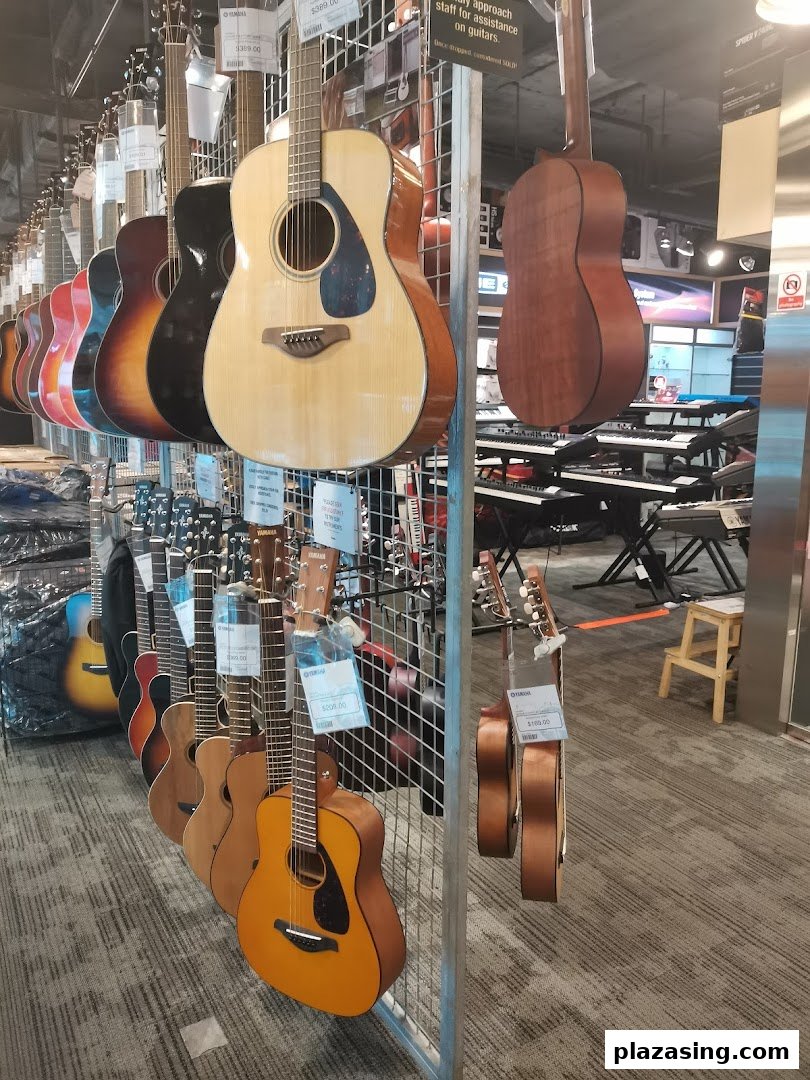 A vibrant display of acoustic guitars and keyboards inside the Yamaha Music Store.