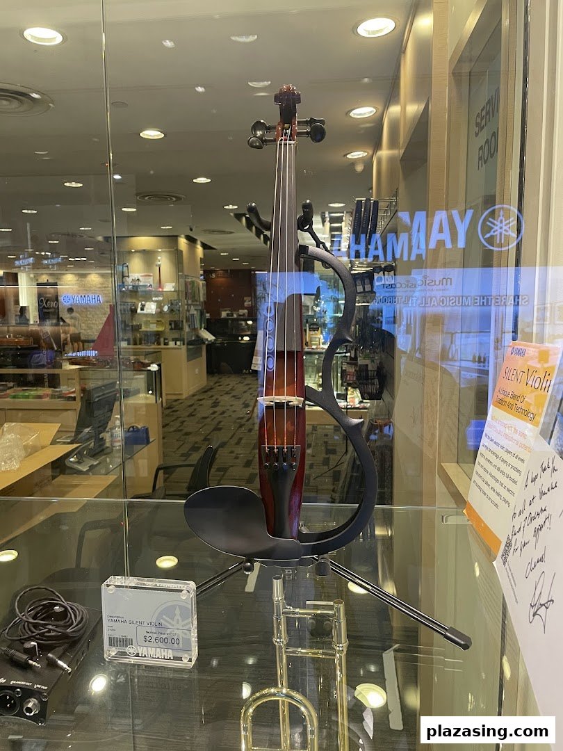 A Yamaha Silent Violin is prominently displayed in a glass showcase at the music store.