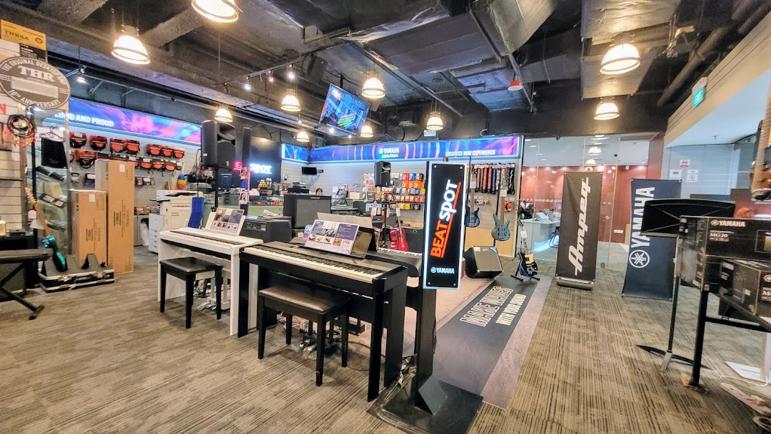 An interior view of the Yamaha Music Store, showcasing various musical instruments and audio equipment.