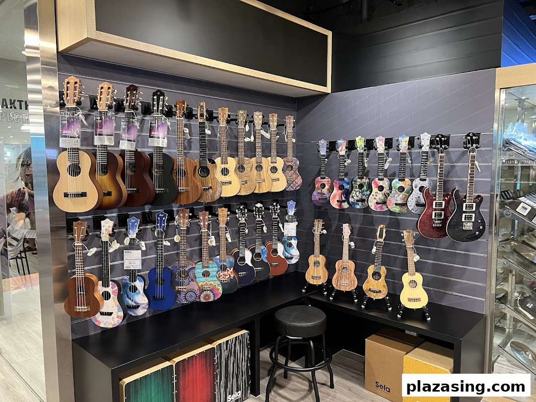 A vibrant display of various ukuleles and guitars on a wall in a music store.