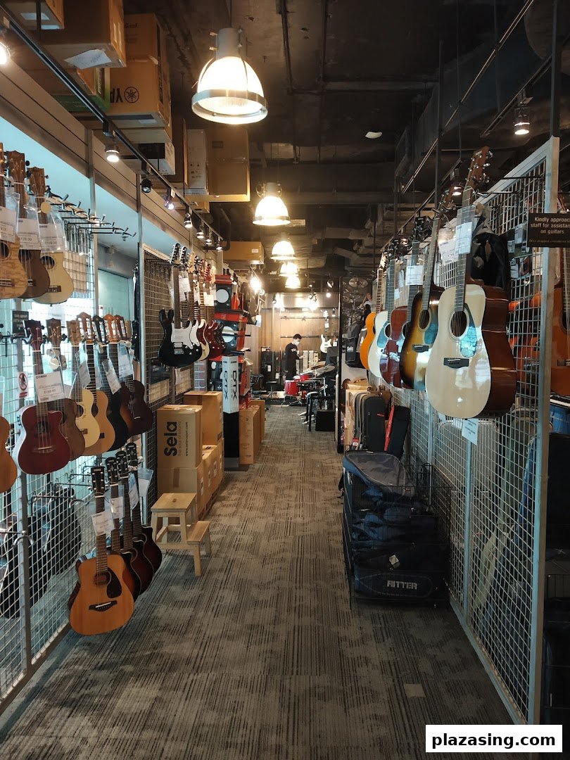 An interior view of Yamaha Music Store, showcasing a wide array of guitars, ukuleles, and other musical instruments.
