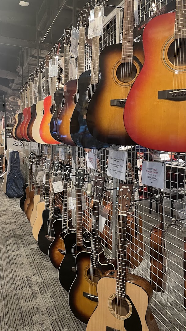 A vibrant display of acoustic guitars lined up for sale in a music store.