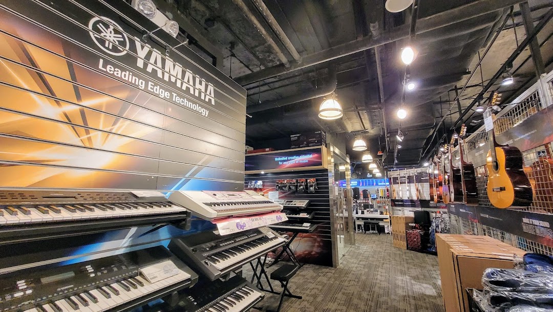 An interior view of the Yamaha Music Store, showcasing various keyboards and guitars.