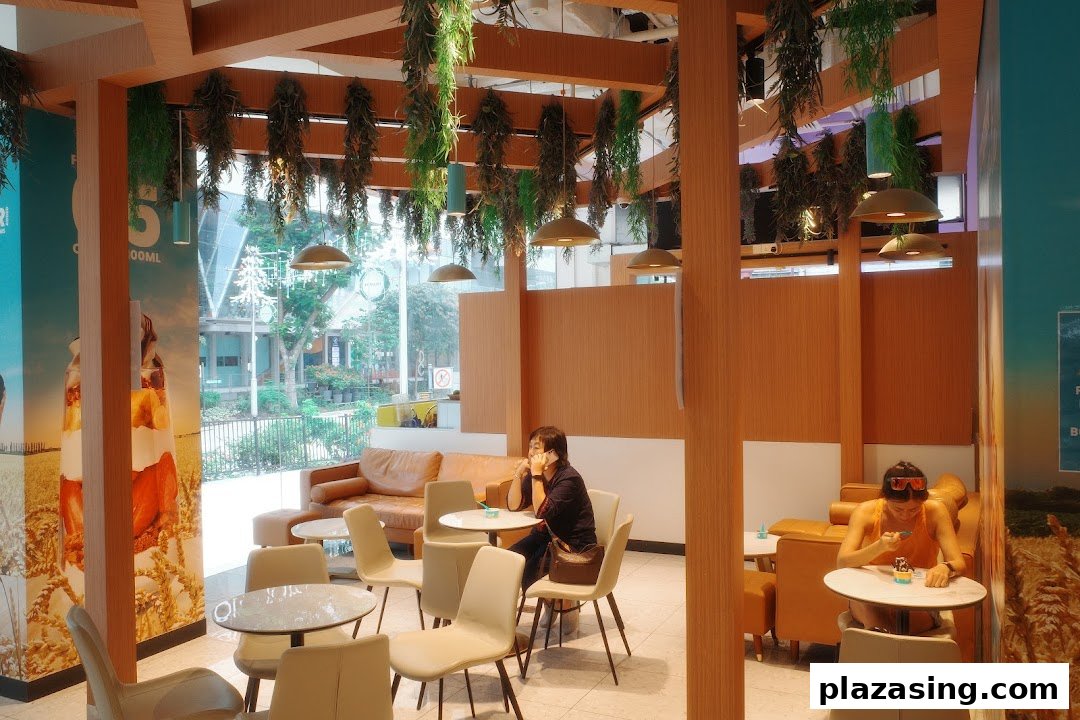 Interior view of Yolé Plaza Singapura, featuring customers enjoying frozen yogurt in a bright, modern setting.