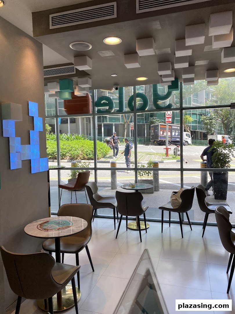 Interior view of Yolé Plaza Singapura, featuring modern seating and large windows overlooking the street.