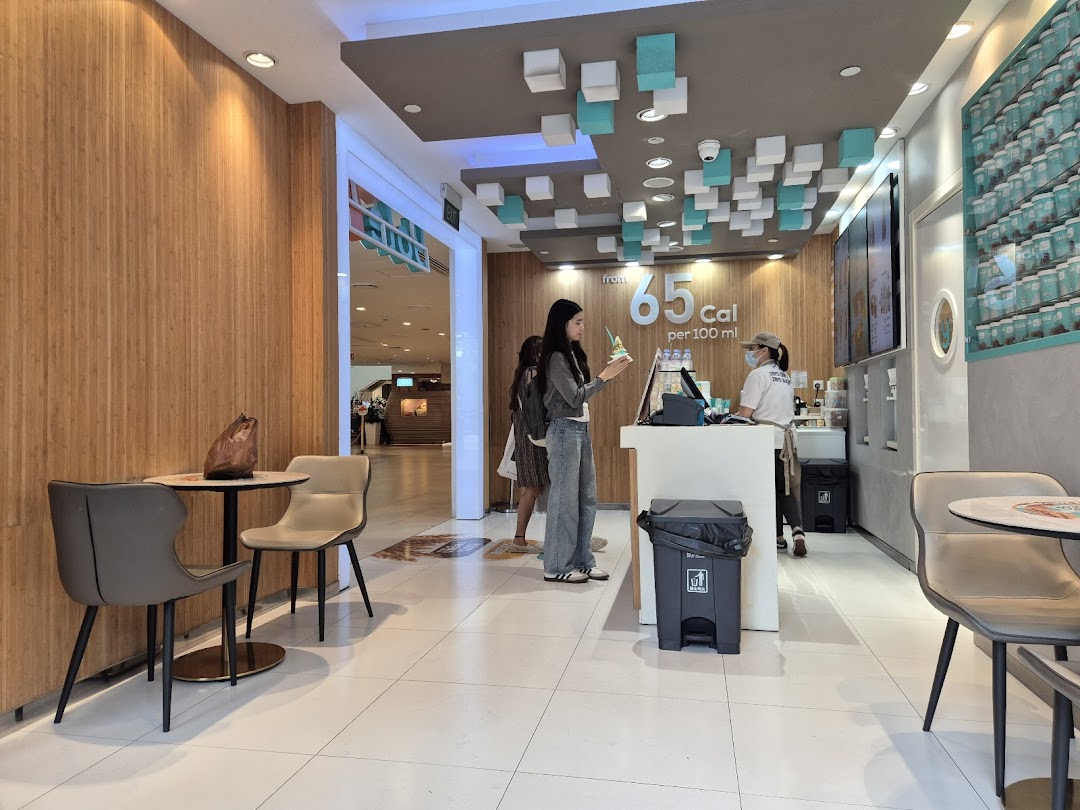 Interior view of Yolé Plaza Singapura, showing the counter, staff, customer, and seating area.