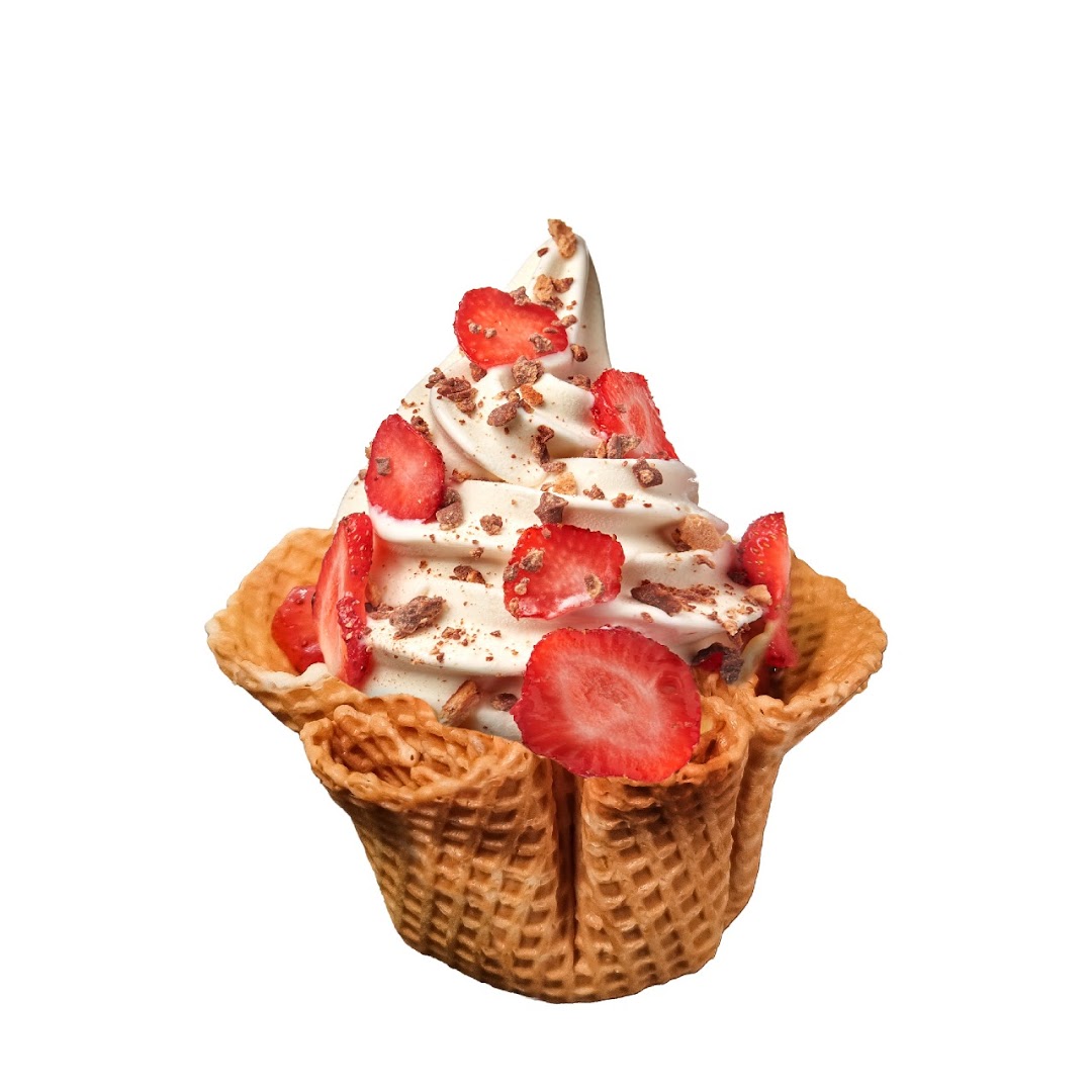A delicious frozen yogurt with fresh strawberries and chocolate toppings in a crispy waffle bowl.