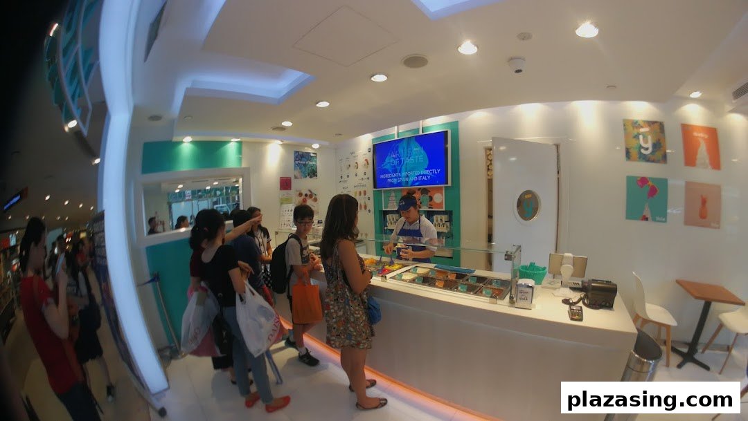 Customers queue at the counter of Yolé, a bright and modern frozen yogurt shop.