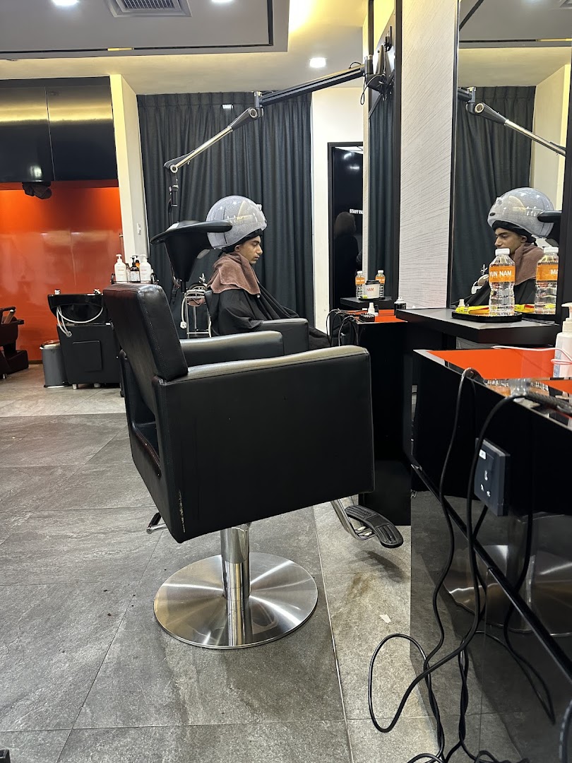 A customer receiving a hair treatment under a steamer at Yun Nam Hair Care.