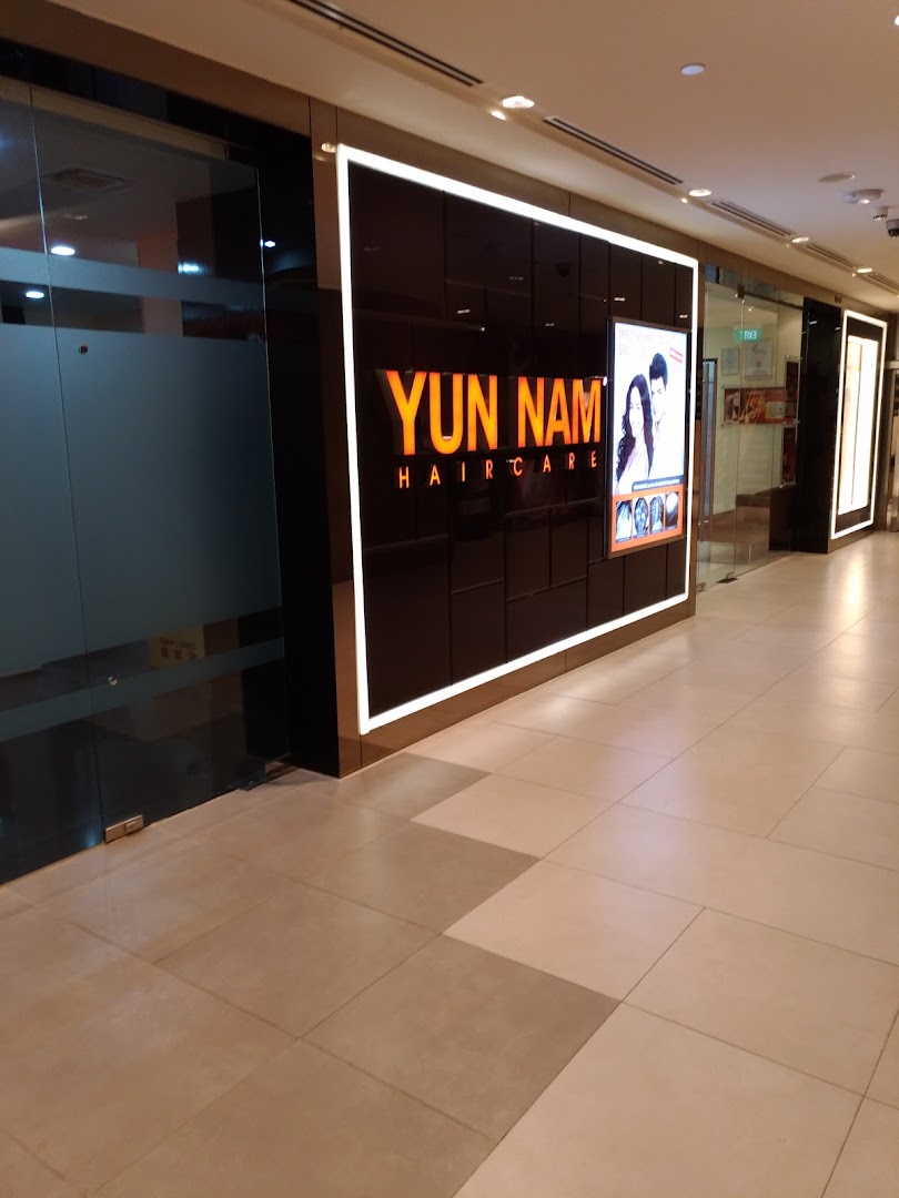 The illuminated entrance of Yun Nam Hair Care, a hair treatment center in a shopping mall.