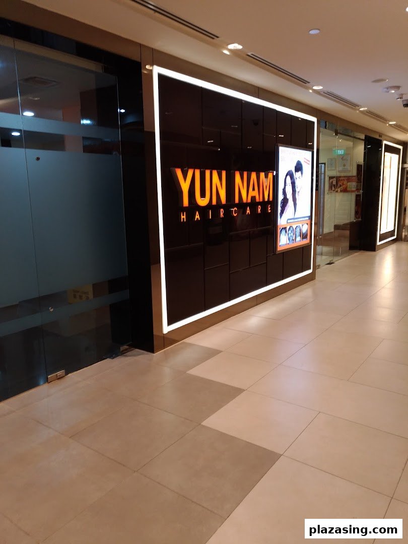 The illuminated entrance of Yun Nam Hair Care, a hair treatment center in a shopping mall.