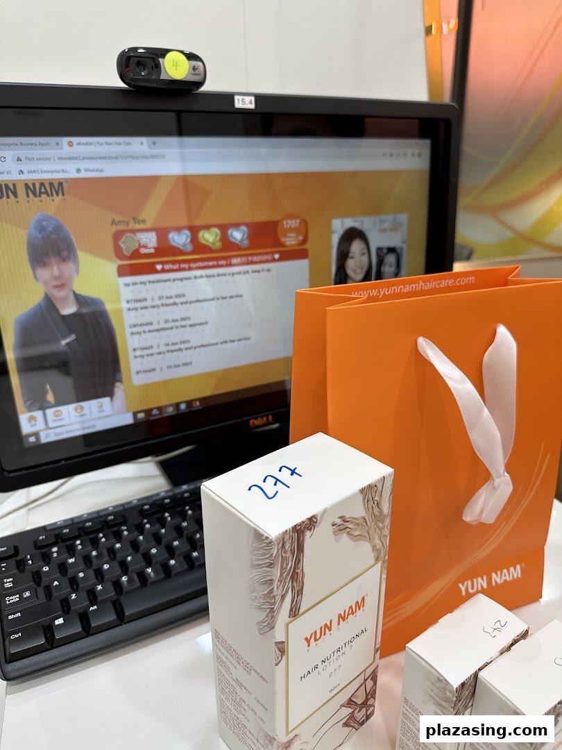 A computer screen displaying customer reviews, a Yun Nam Hair Care product box, and an orange shopping bag.