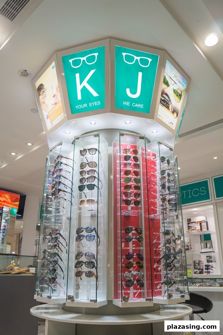 A central display stand showcasing numerous pairs of sunglasses and eyeglasses inside an optical shop.