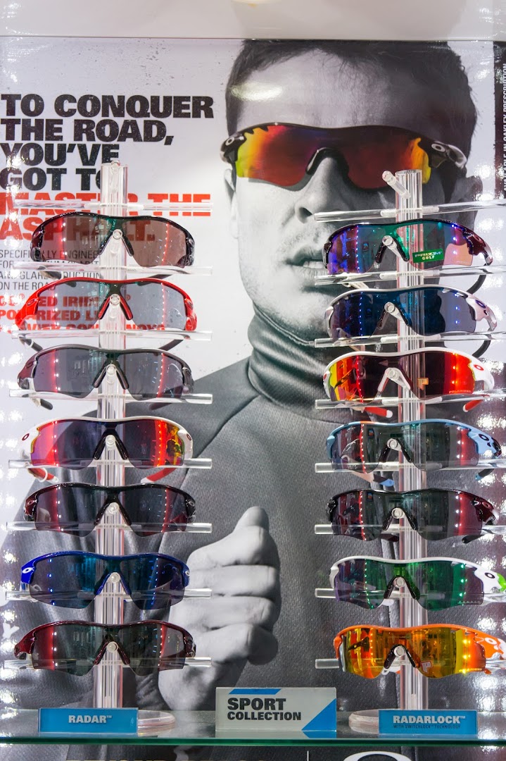 A vibrant display of performance sports sunglasses, featuring various models and lens colors, set against a promotional backdrop.