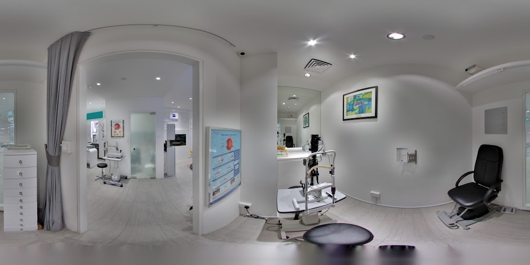 An interior view of ZEISS VISION CENTER by KJ Optometrists, showcasing modern eye examination equipment and a clean environment.