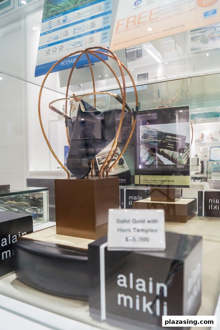Close-up of a display case inside an optical shop, featuring eyeglasses, contact lenses, and product information.
