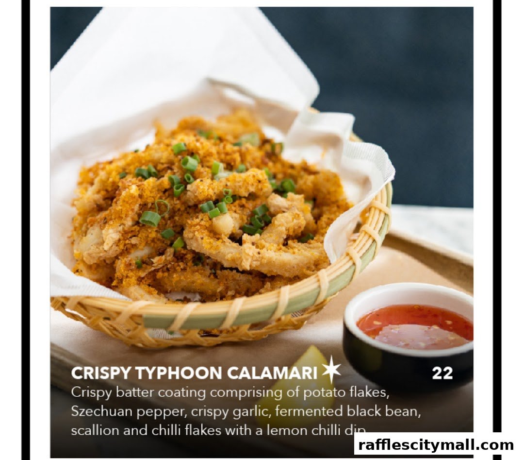 A basket of crispy calamari with a side of chili dip, garnished with scallions.
