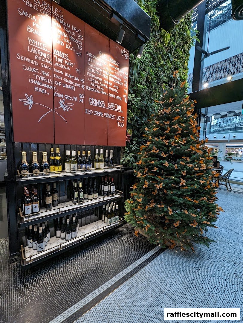 A wine display and a Christmas tree decorated with monarch butterflies.