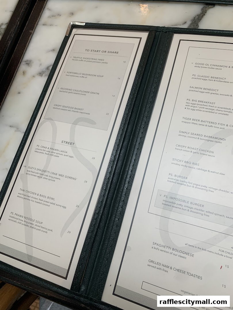 A close-up view of a restaurant menu with various food and drink items listed.