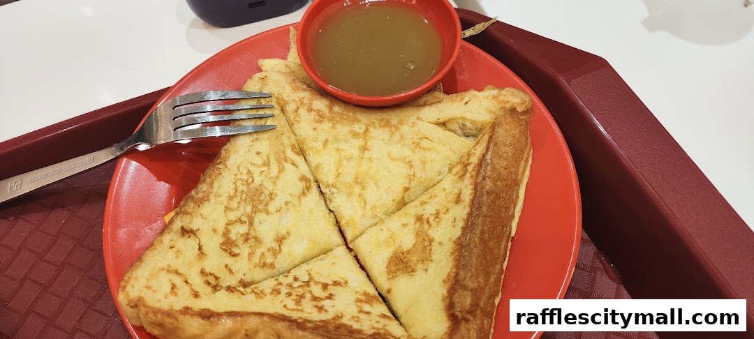 A plate of kaya toast with a small bowl of kaya dip and a fork.