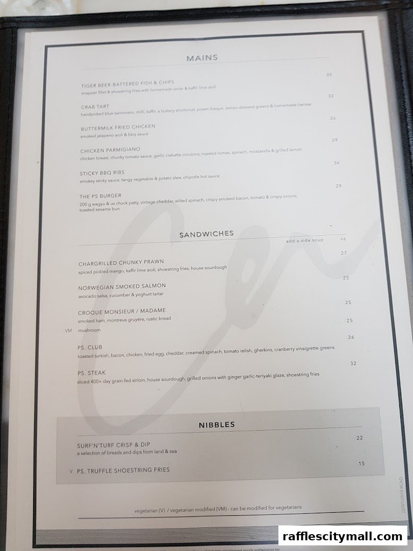 A menu from PS.Cafe Raffles City featuring mains, sandwiches, and nibbles.