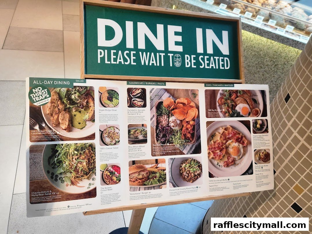 A menu board displaying various dishes from Tiong Bahru Bakery with enticing food photography.