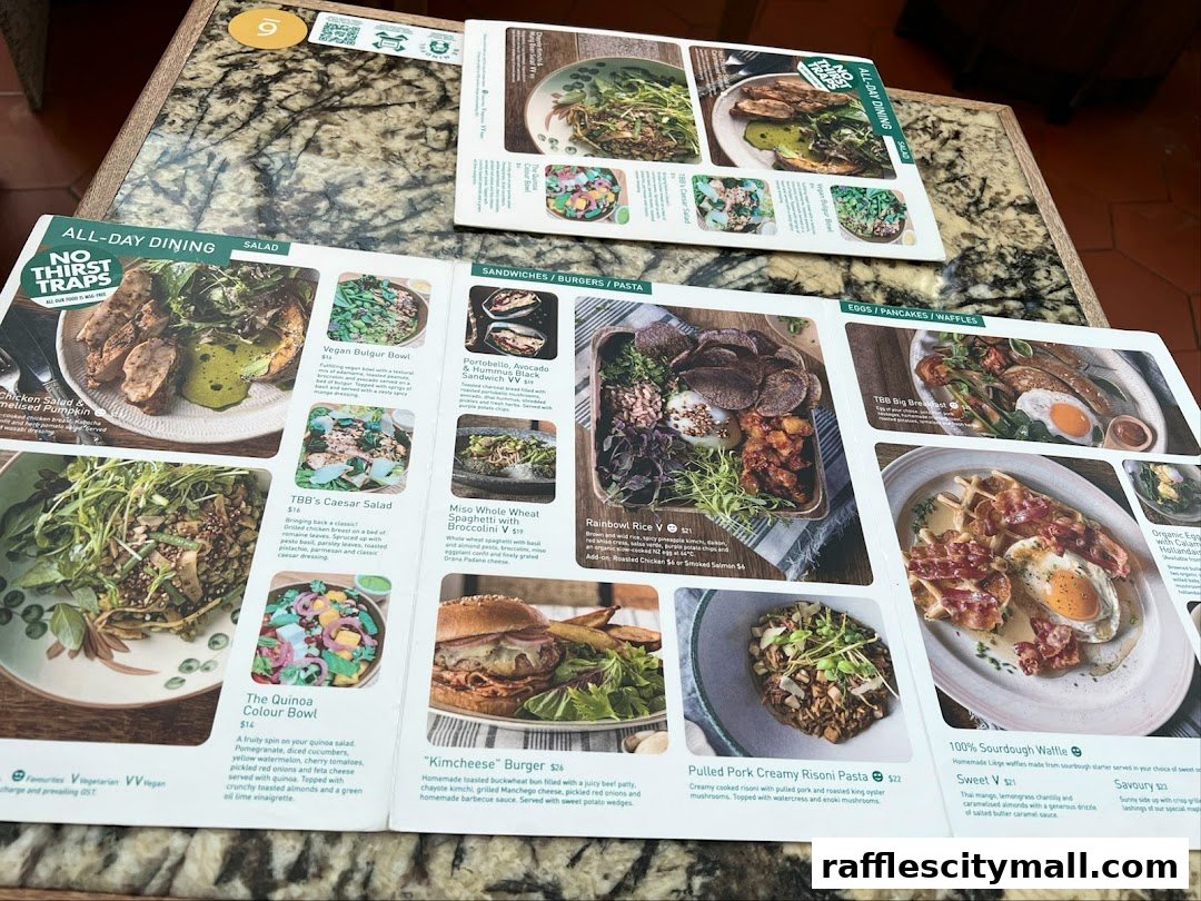 A menu from Tiong Bahru Bakery featuring various dishes like salads, burgers, pasta, and waffles.