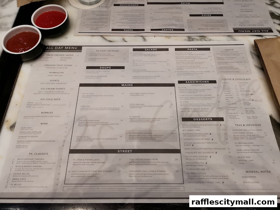 A menu from PS.Cafe Raffles City with various food and drink categories and prices.