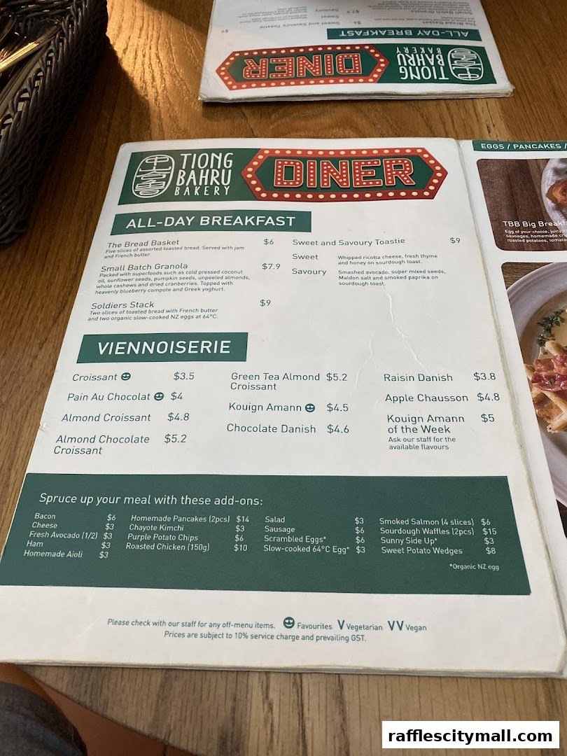 A menu from Tiong Bahru Bakery featuring all-day breakfast, viennoiserie, and add-ons.