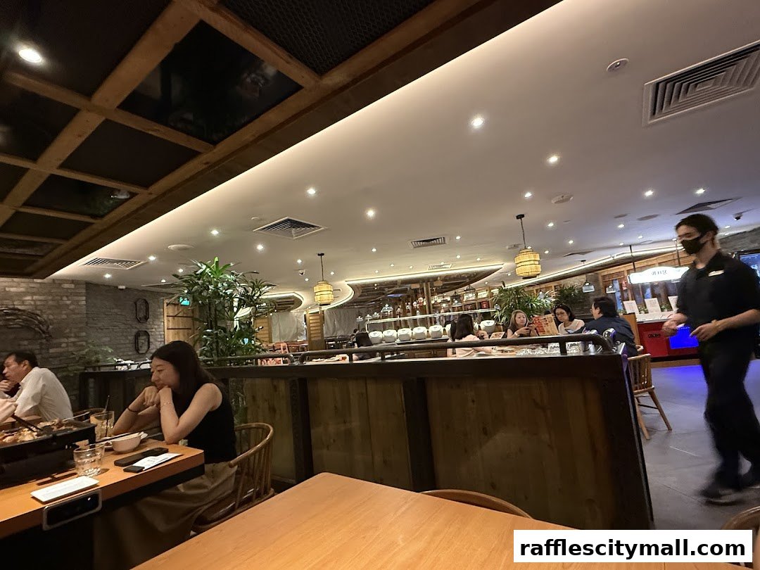 Diners enjoying a meal at Riverside Canton Claypot Cuisine, with staff serving.