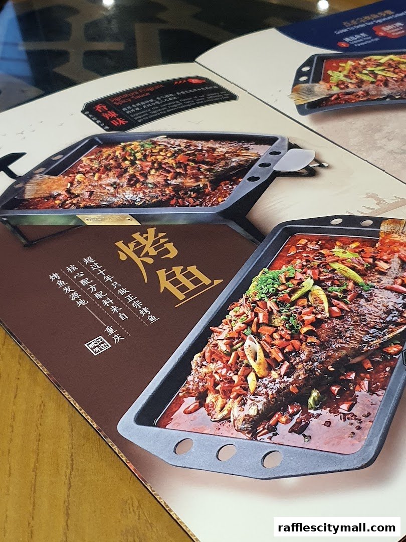 A menu page showcasing two visually appealing dishes of grilled fish in spicy sauce.