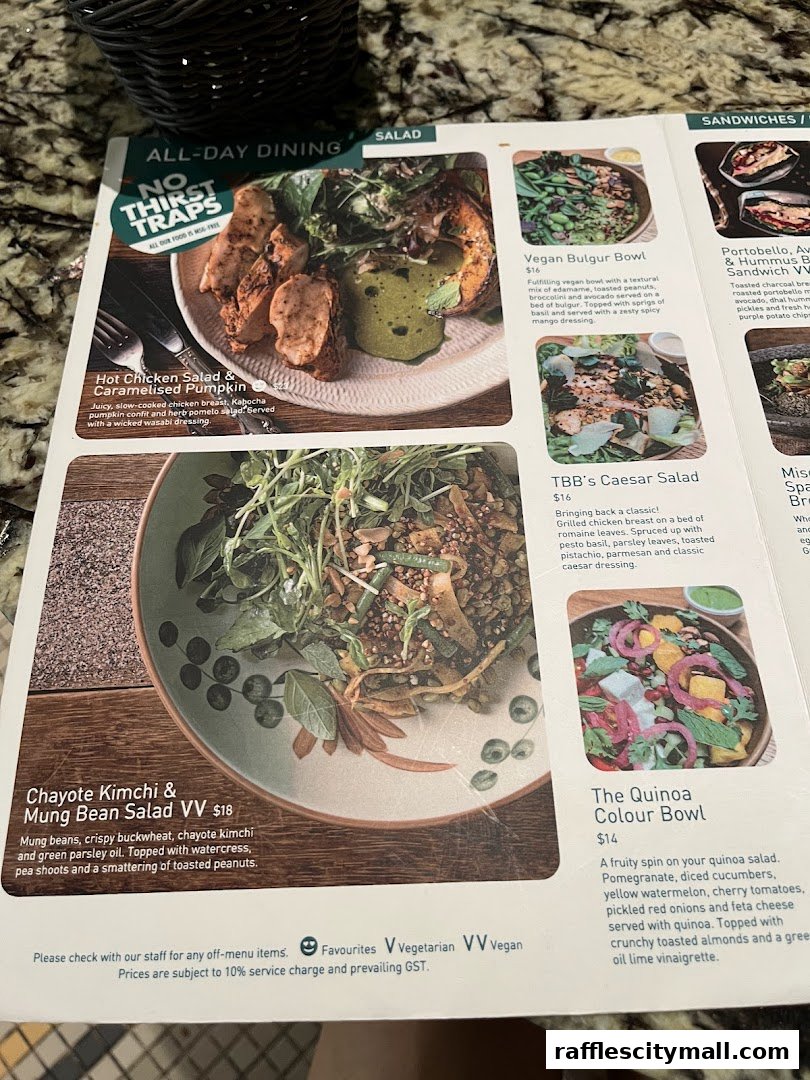 A menu from Tiong Bahru Bakery featuring salads and sandwiches with enticing descriptions and prices.