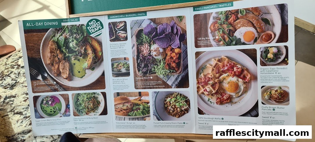 A menu from Tiong Bahru Bakery showcasing various dishes like salads, sandwiches, burgers, pasta, eggs, pancakes, and waffles.