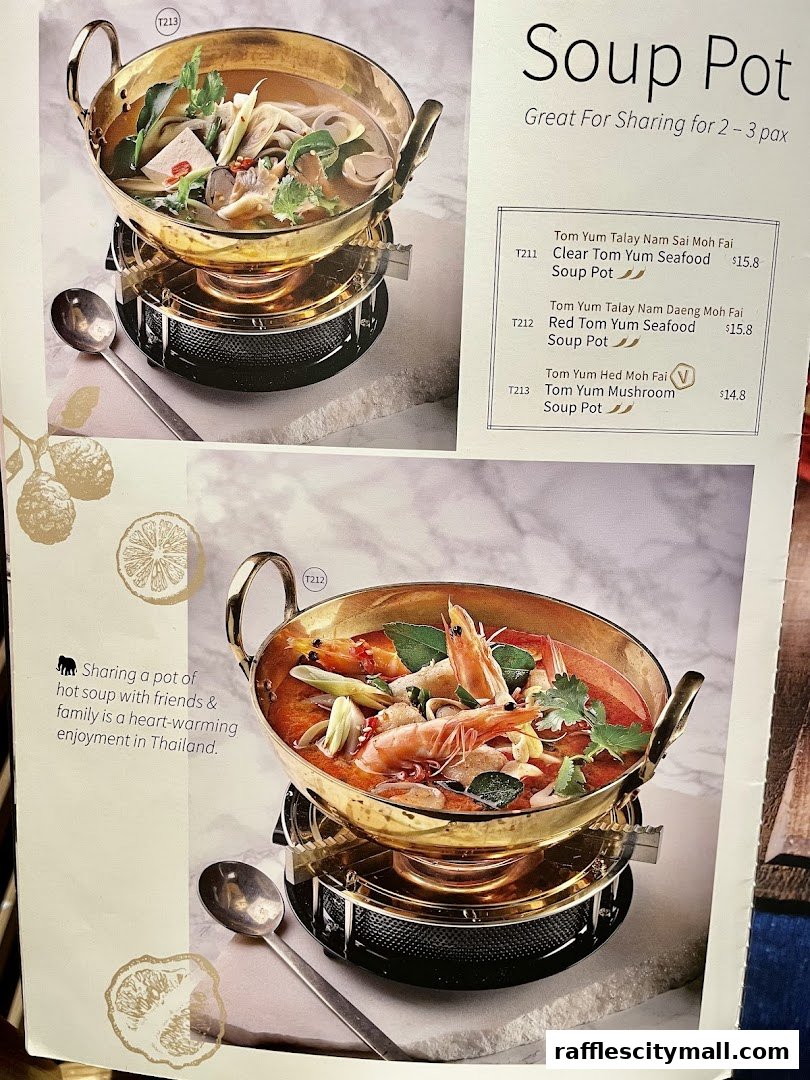 A menu page showcasing two steaming Thai soup pots, one clear seafood and one red seafood.