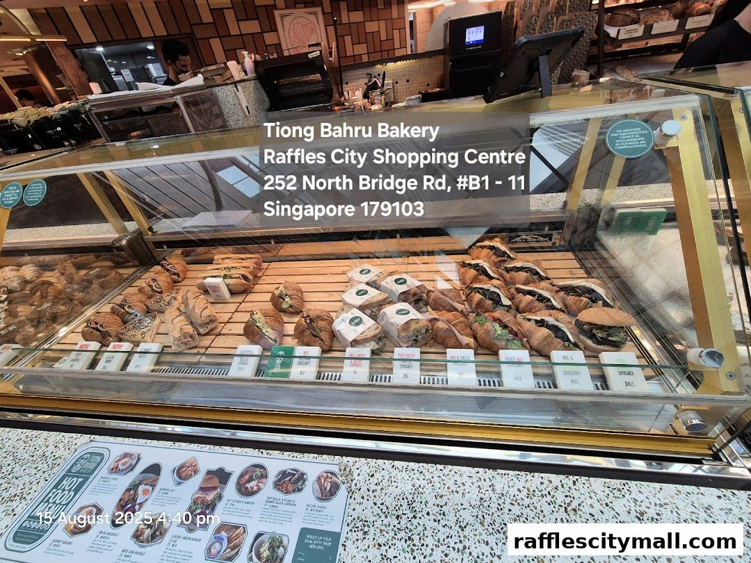 A display case filled with assorted croissants and sandwiches at Tiong Bahru Bakery.