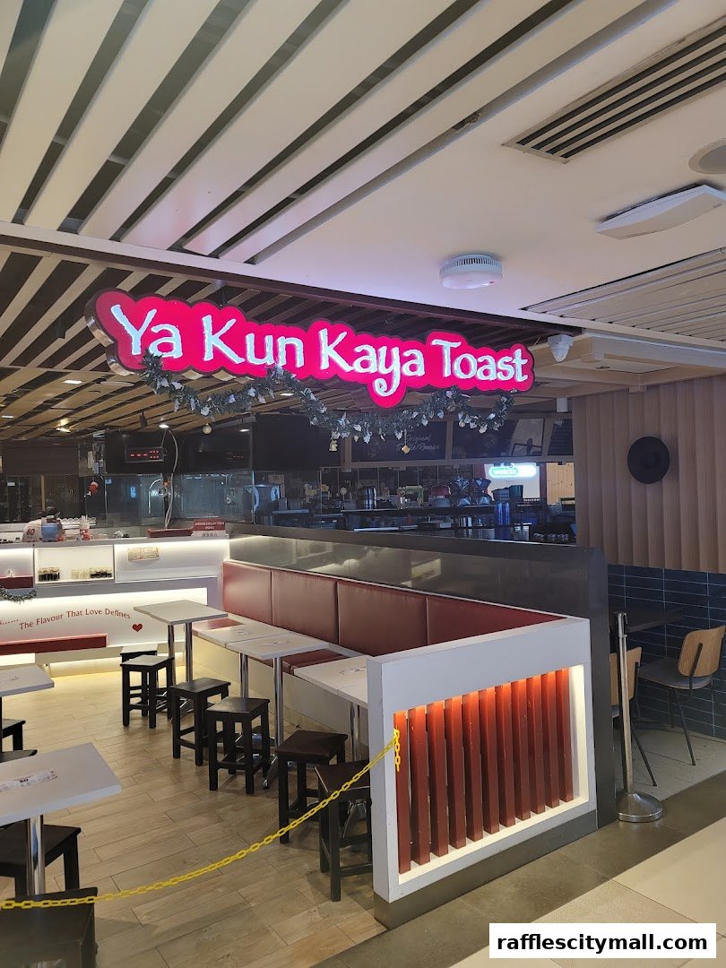 The Ya Kun Kaya Toast shop front with seating and a prominent neon sign.