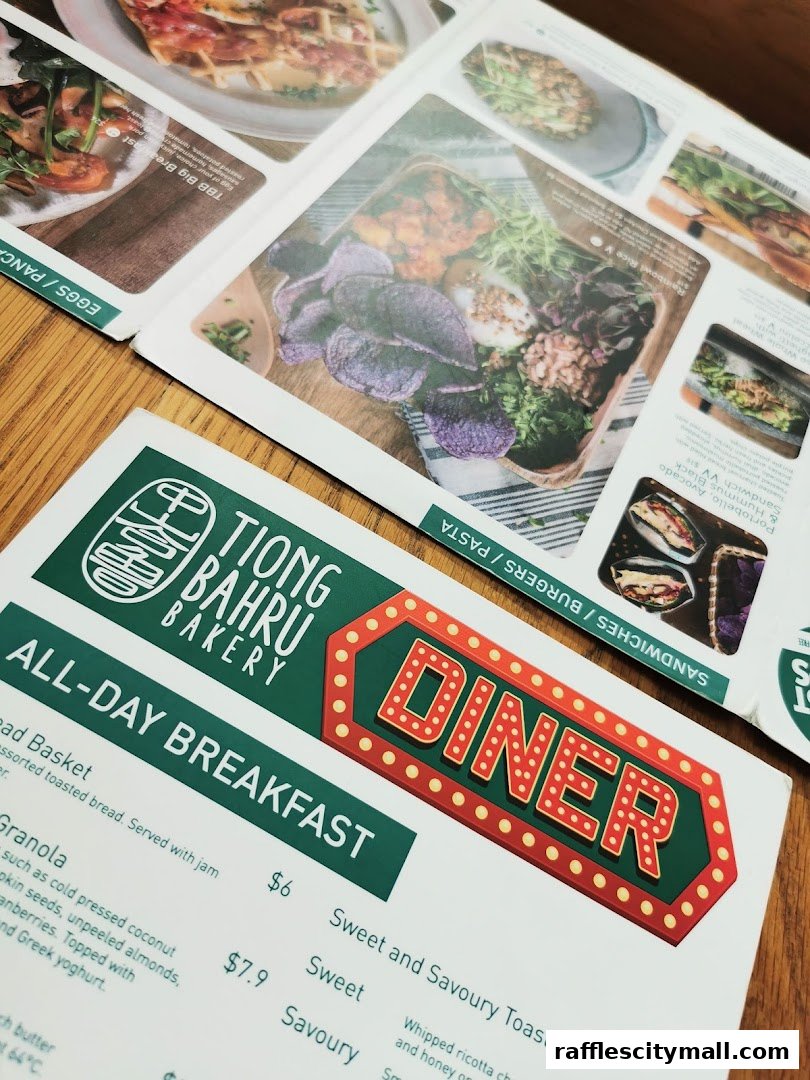 A close-up view of a Tiong Bahru Bakery menu featuring breakfast items and diner-style food.