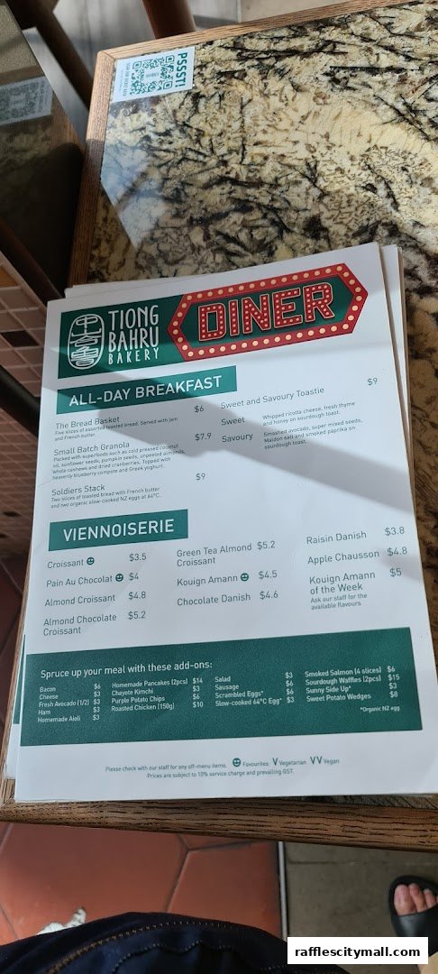 A menu from Tiong Bahru Bakery featuring all-day breakfast, viennoiserie, and add-ons.