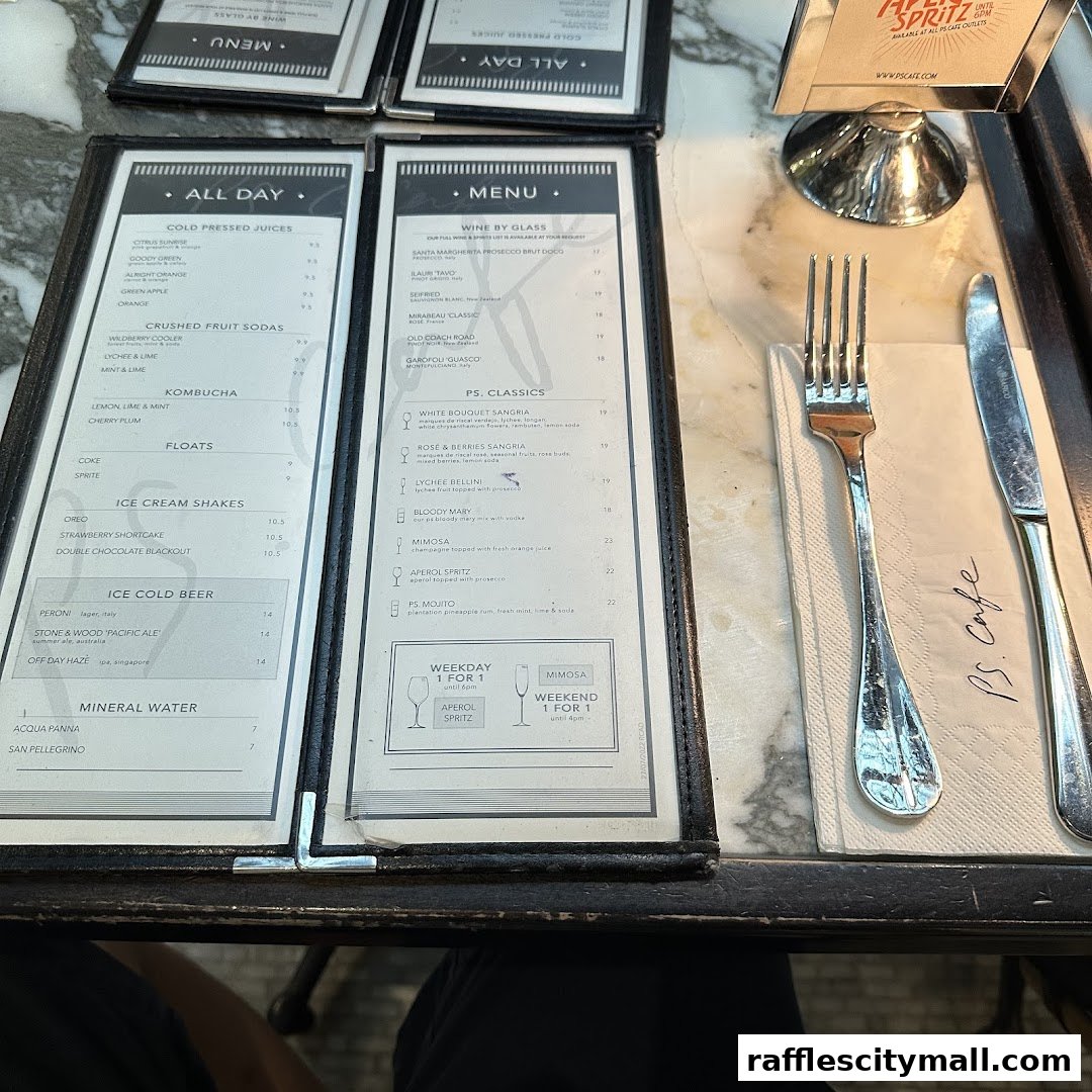 A close-up view of a menu from PS.Cafe Raffles City, featuring drinks and ice cream.